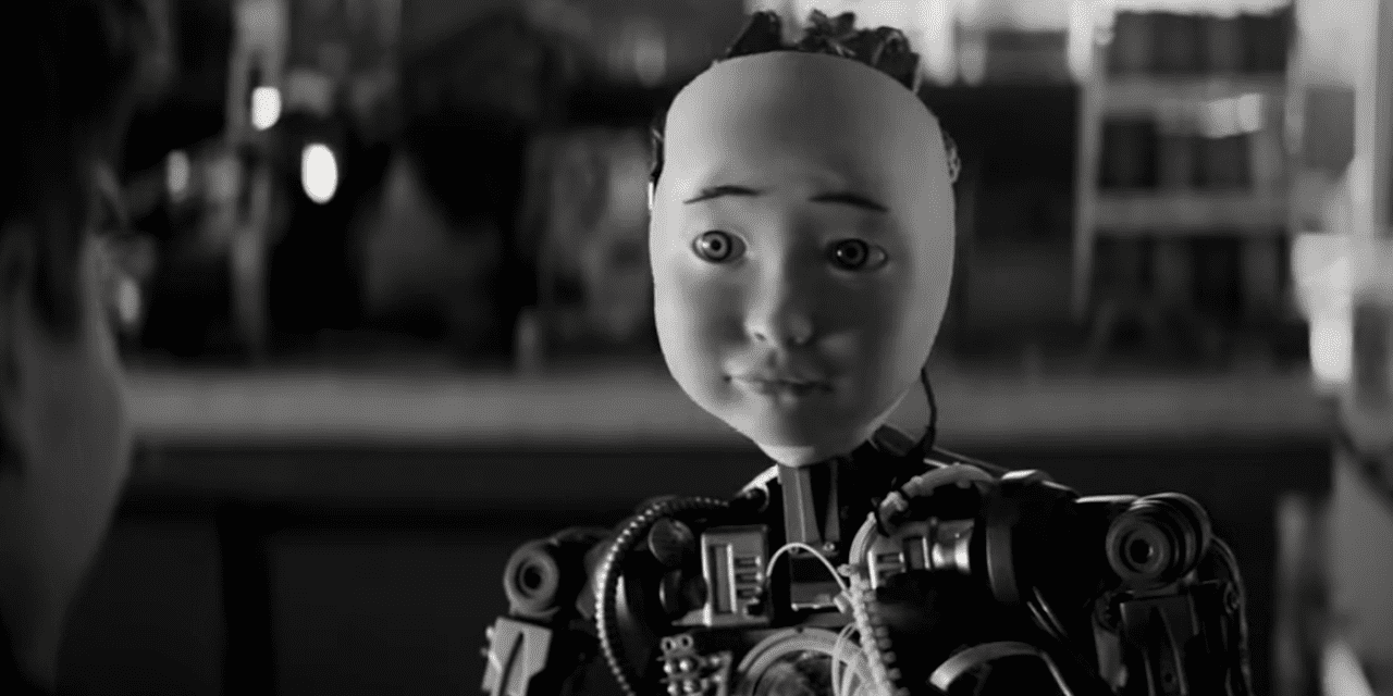 Black and white image of a humanoid robot with an exposed mechanical body and a smooth, expressionless face