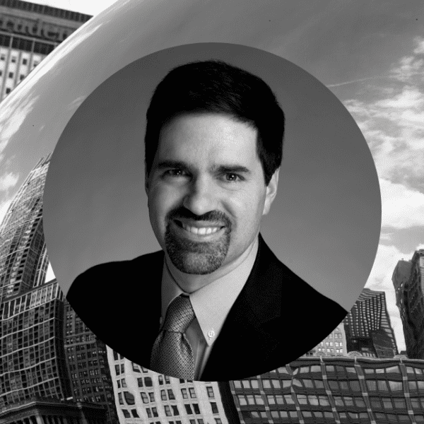 A black and white image of a man dressed in a formal suit and tie, exuding professionalism and elegance.