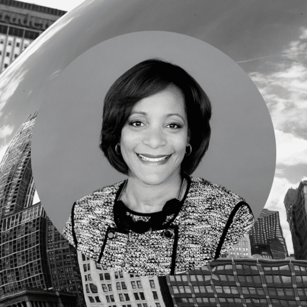 A woman stands confidently in front of a large bean, showcasing her unique surroundings and the whimsical nature of the scene.